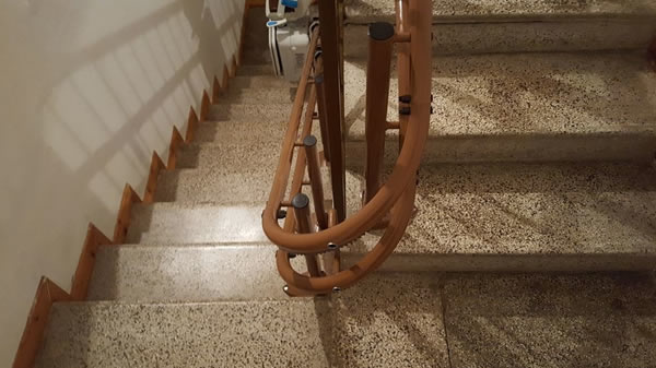 Particolare di un Montascale con poltroncina, modello curvilineo a doppia guida in edificio di Ponzone