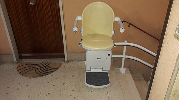 Foto di montascale sottile ma con sedile capiente e braccioli distanziati